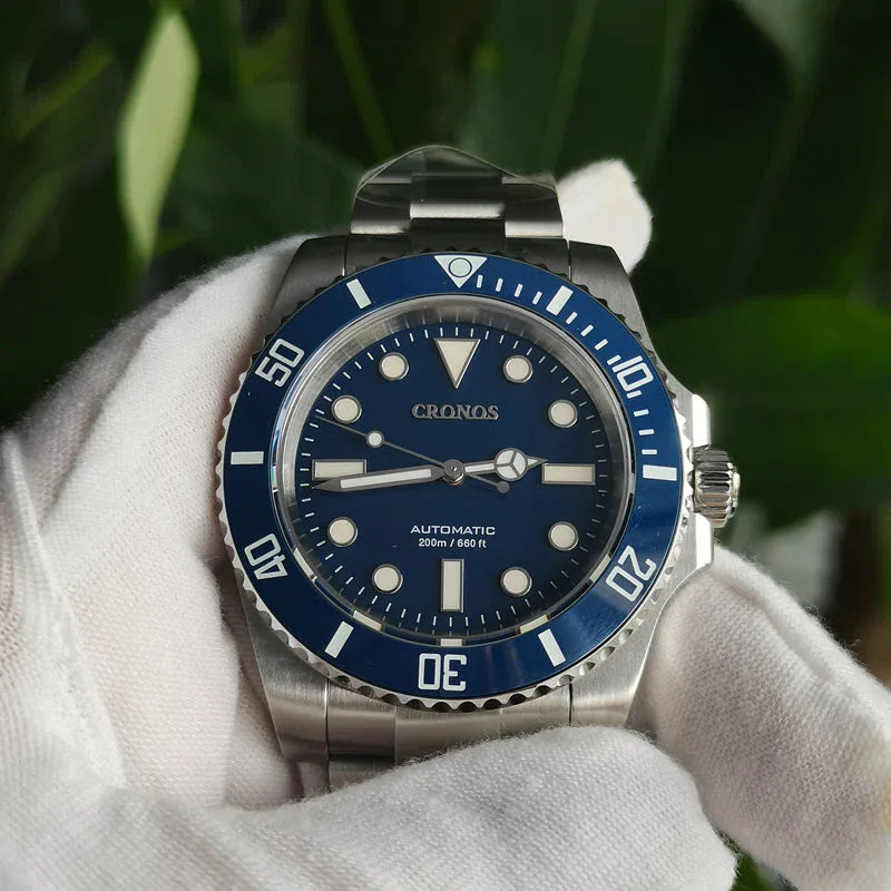 Cronos L6005 diver watch, blue dial and bezel, steel bracelet, held in gloved hand