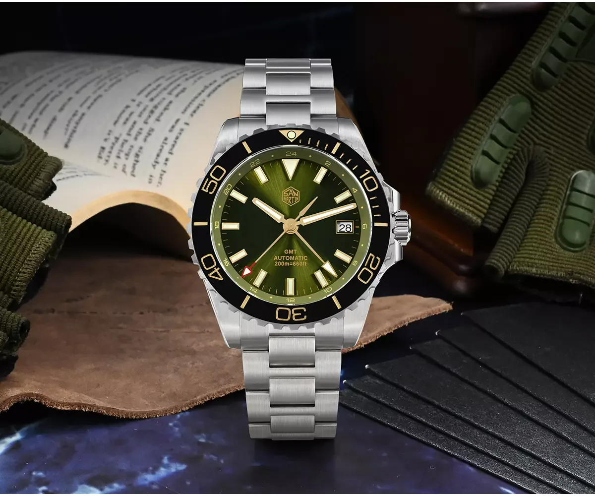 San Martin GMT automatic watch with green sunburst dial, black gold-numeral bezel and steel bracelet, staged with props