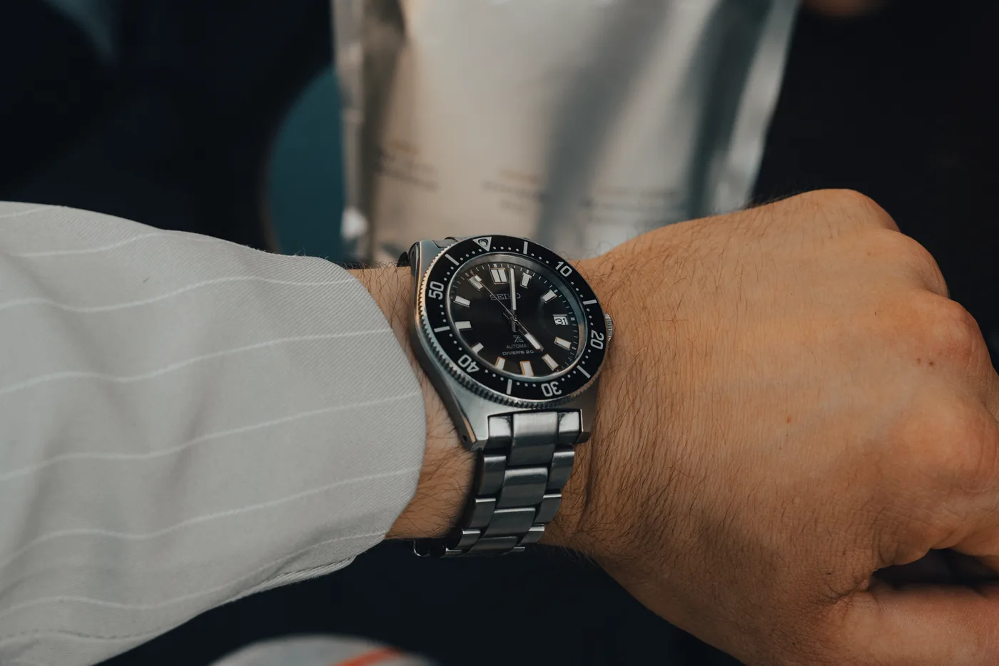 Seiko Prospex SPB143 diver worn on the wrist, dark sunray dial, black bezel, steel bracelet, date at 3.