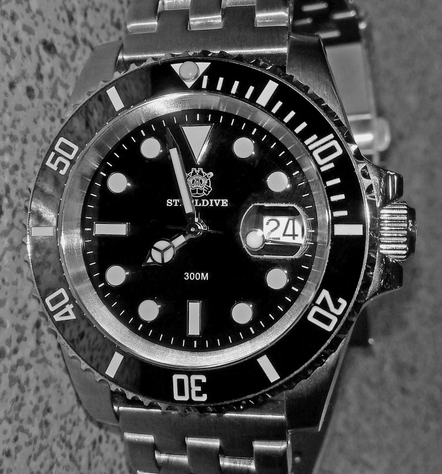 A steel dive watch with a rotating bezel, photographed face on