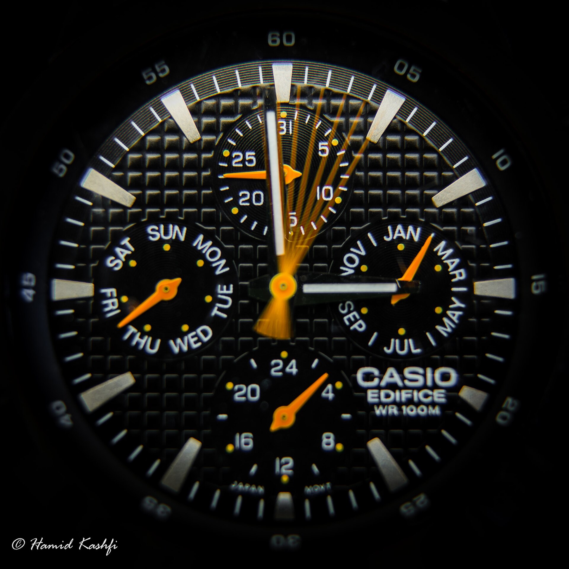 A macro photograph of a watch dial in low light